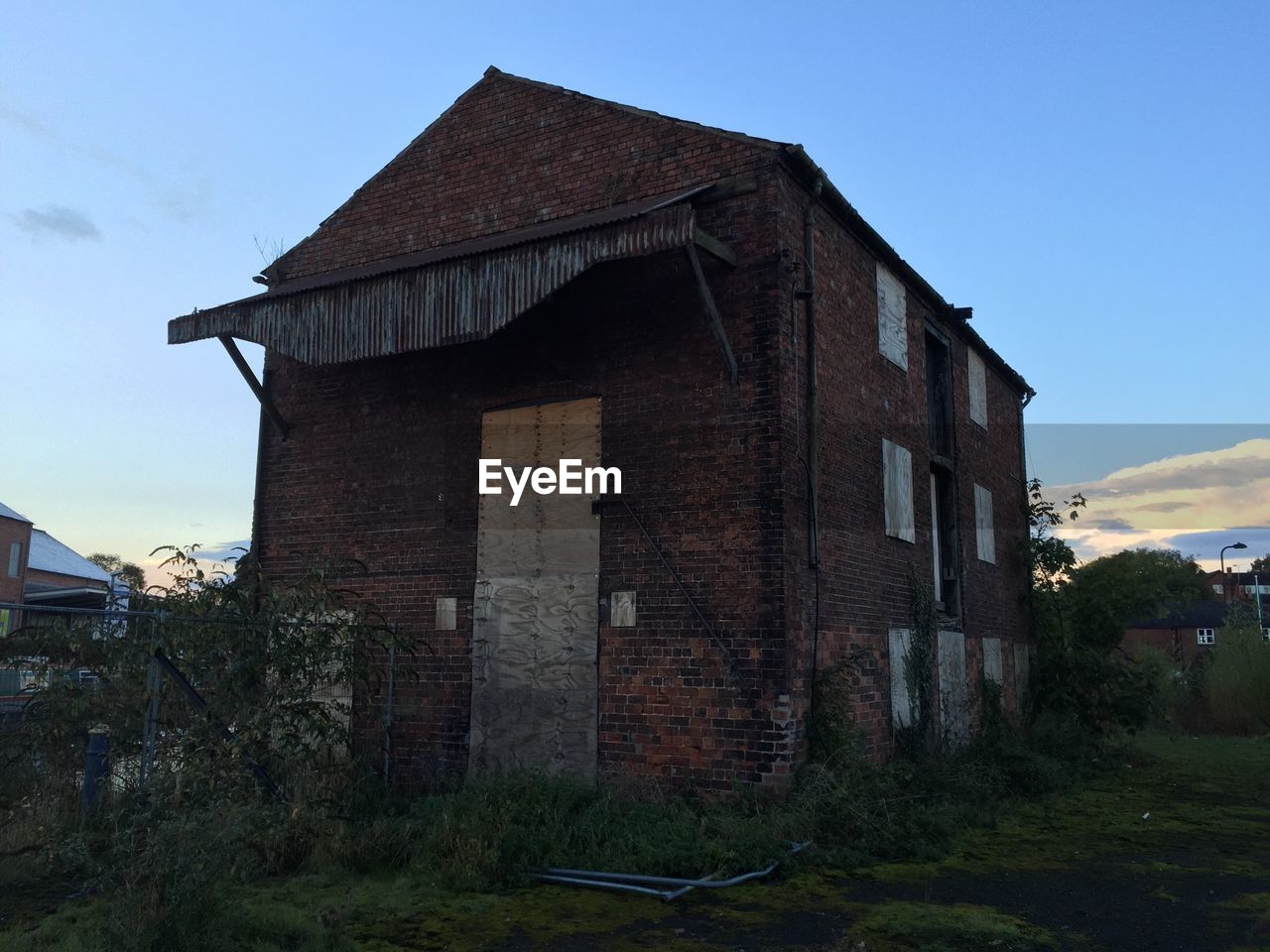 Low angle view of old house on field against sky