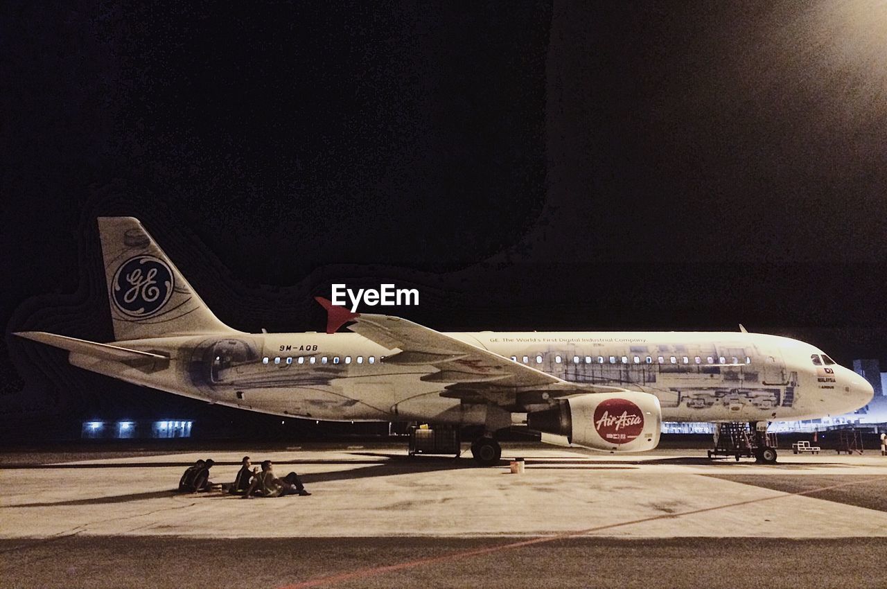 AIRPLANE AT AIRPORT RUNWAY