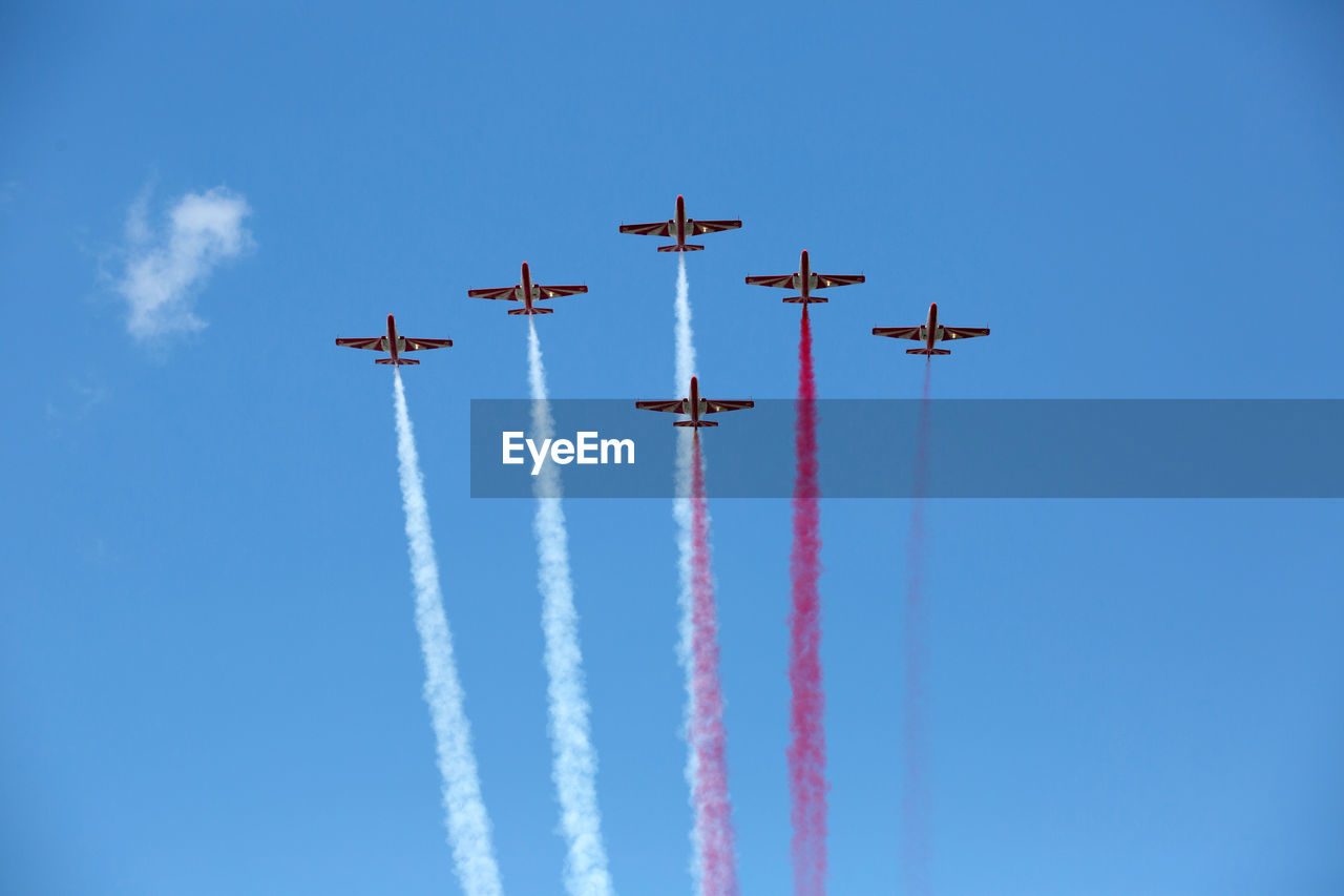 LOW ANGLE VIEW OF AIRPLANE FLYING IN SKY