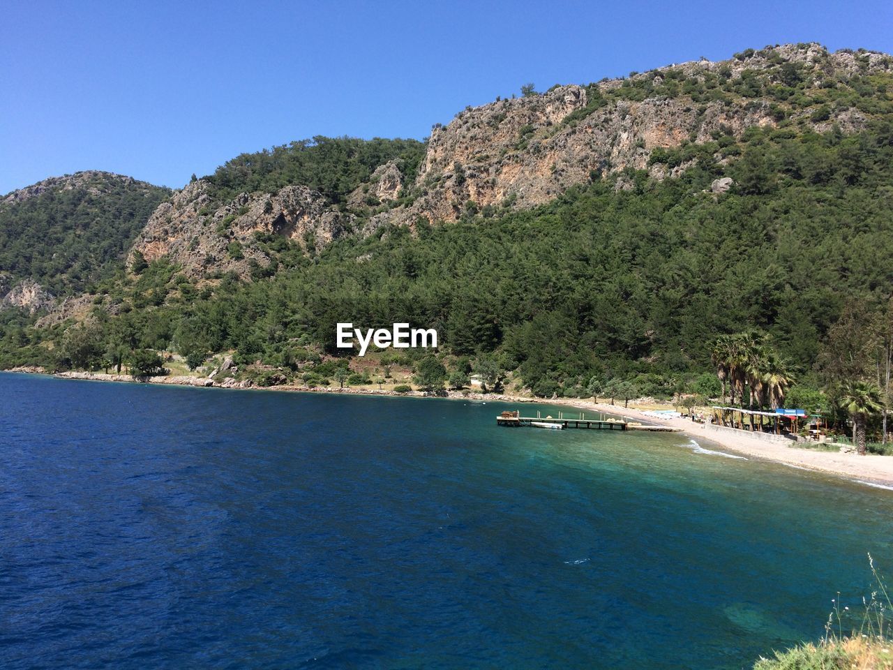 Scenic view of sea against clear blue sky