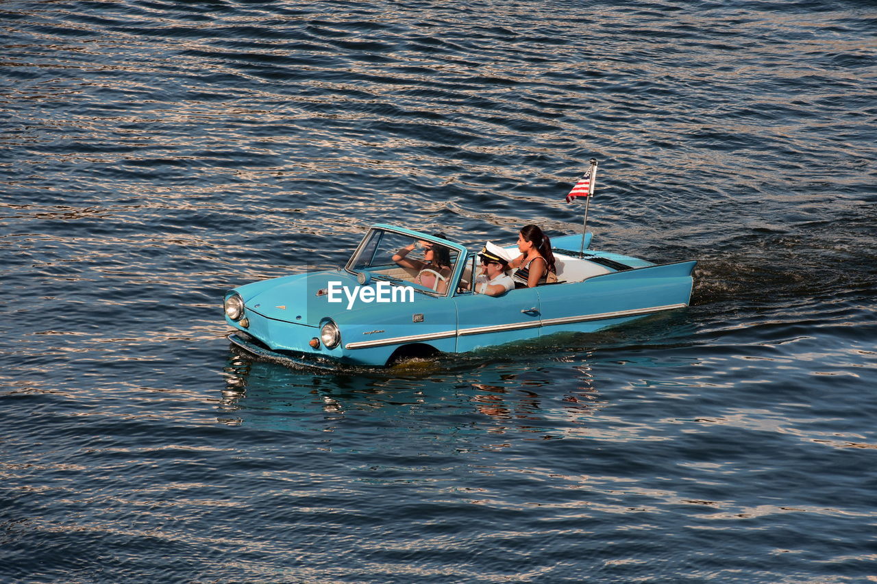 PEOPLE IN BOAT ON SEA SHORE