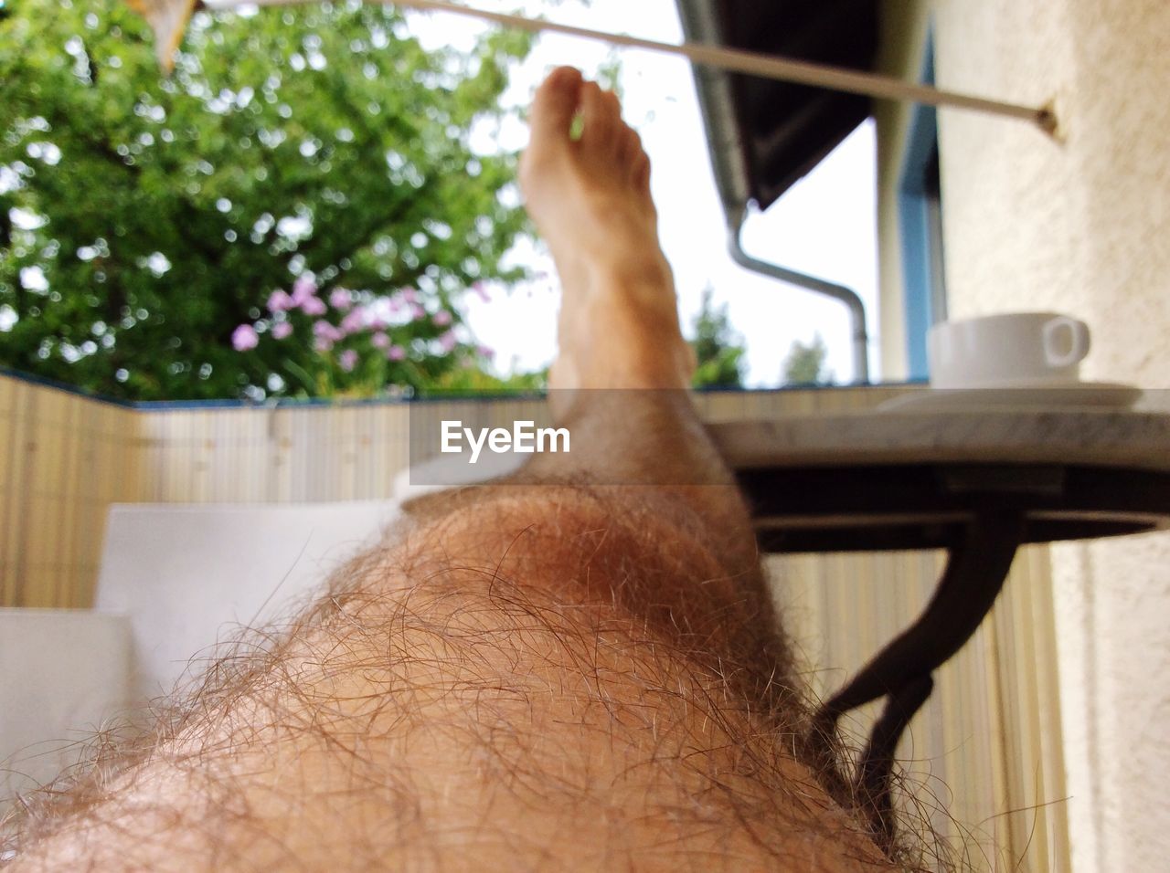 Cropped leg on table in balcony