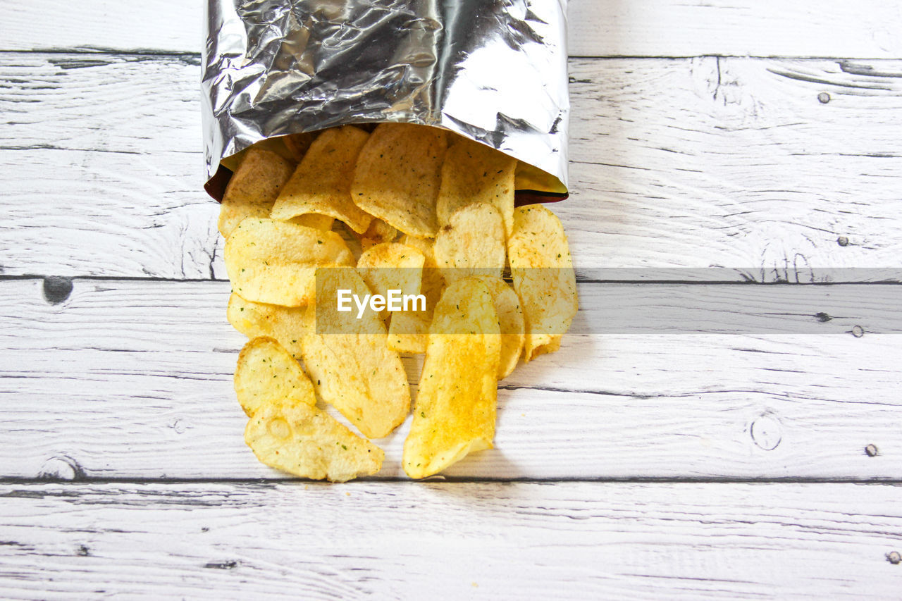 Potato chips and pack. packaging of chip on white background. top view.