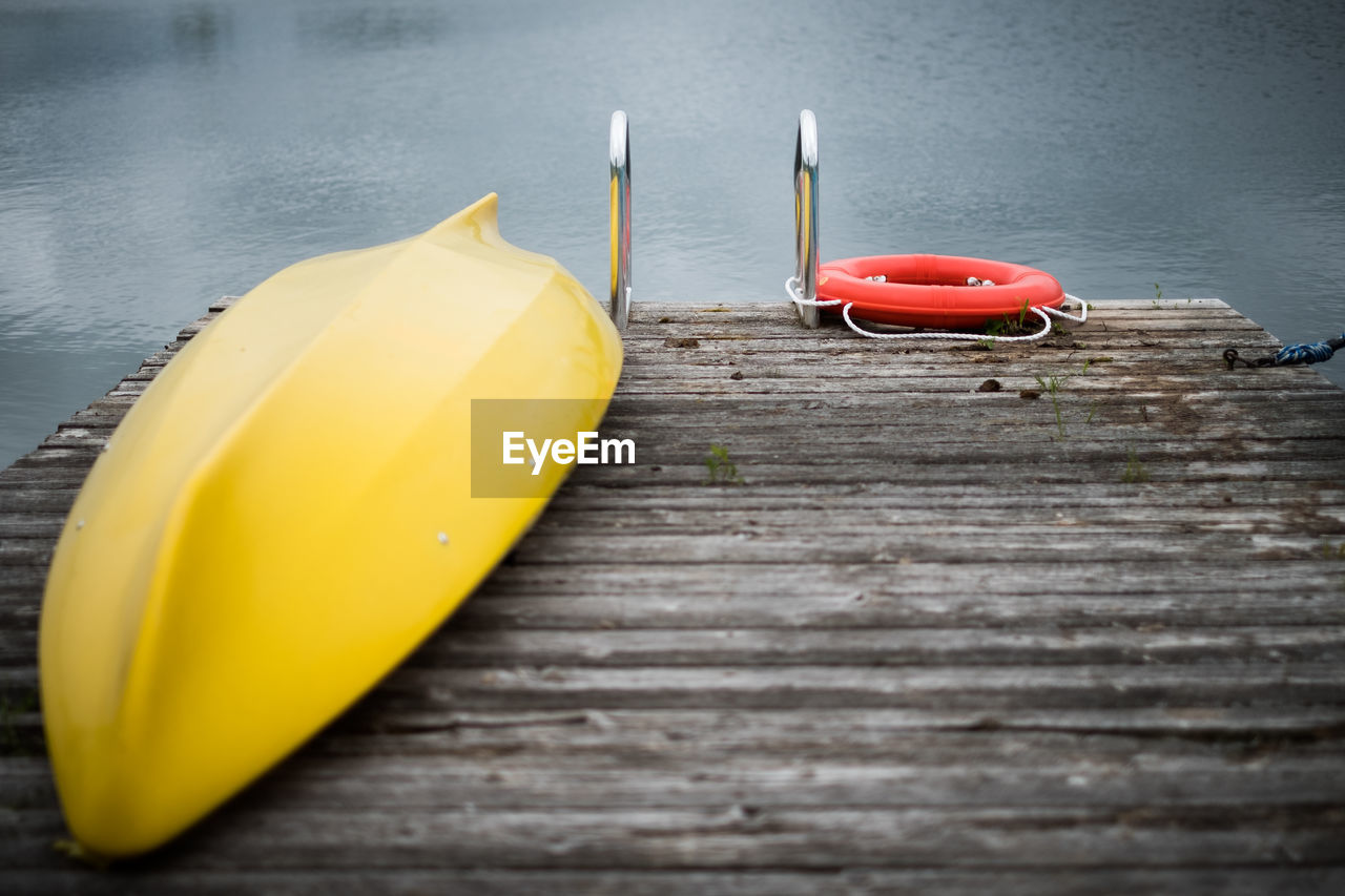 HIGH ANGLE VIEW OF TOY ON TABLE AGAINST BOAT