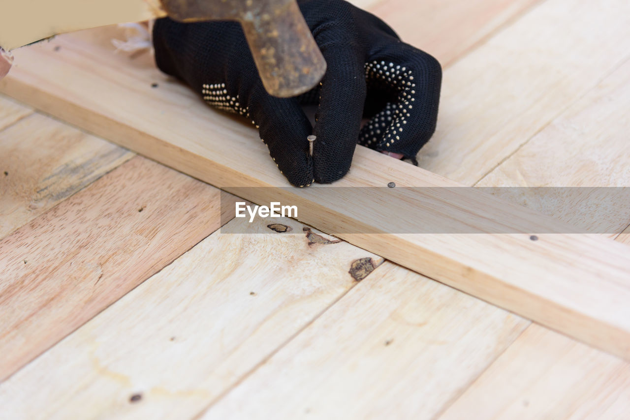 Cropped image of carpenter working with hammer