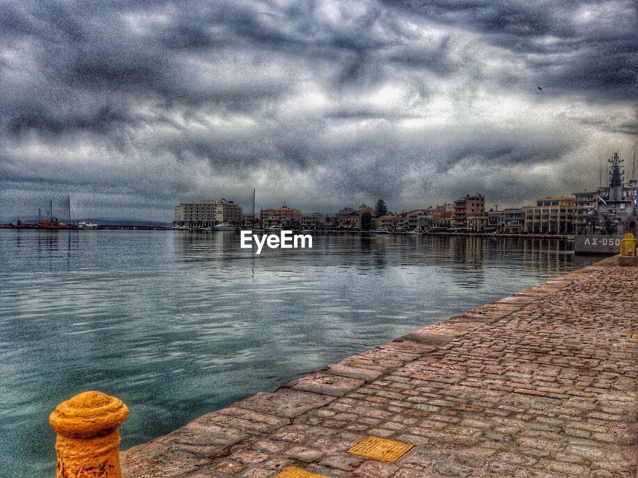 PIER ON SEA AGAINST CLOUDY SKY