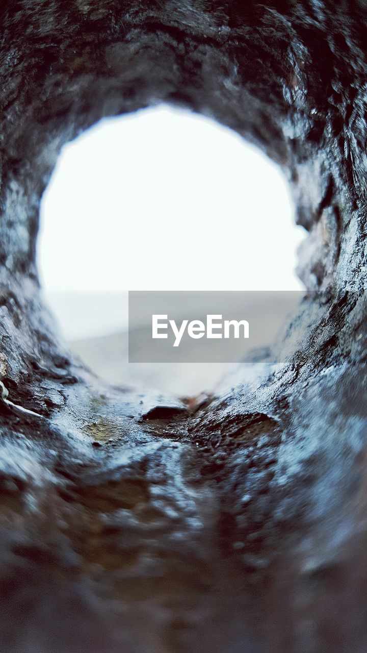 Beach seen through hole in stone