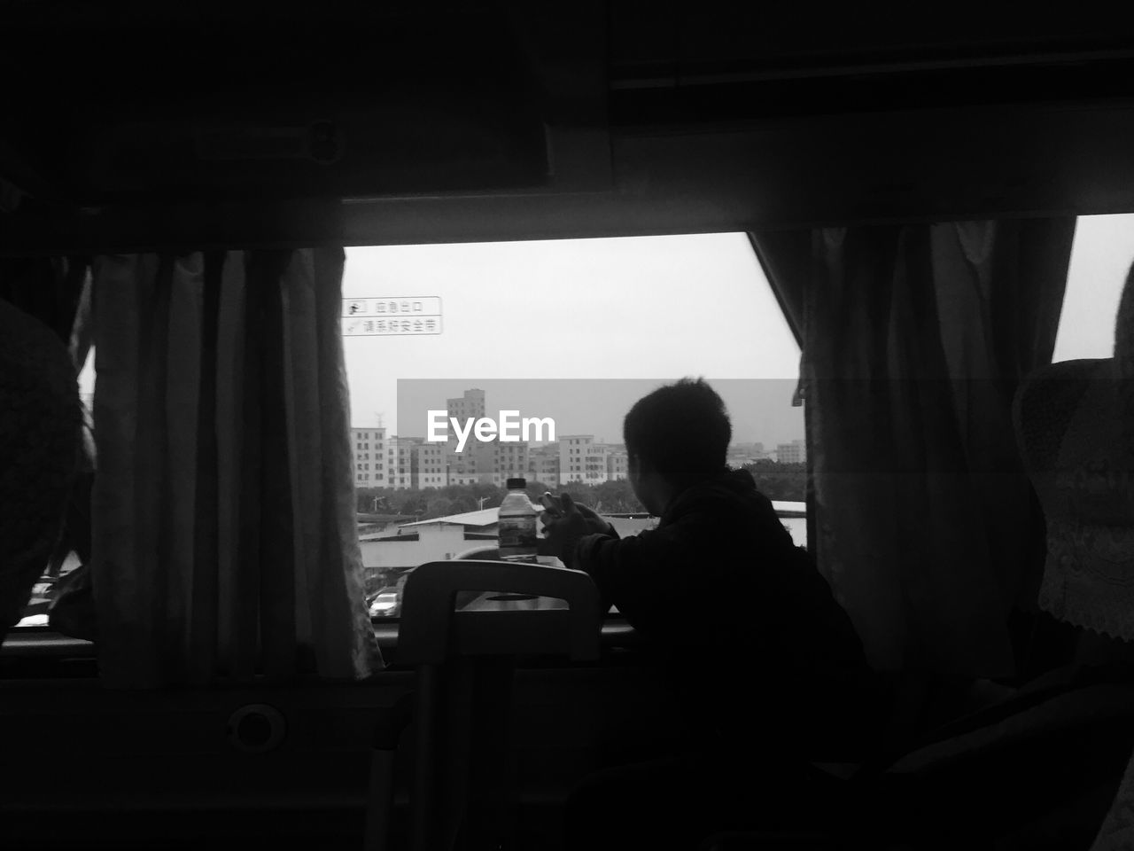 Man looking through window while traveling in train