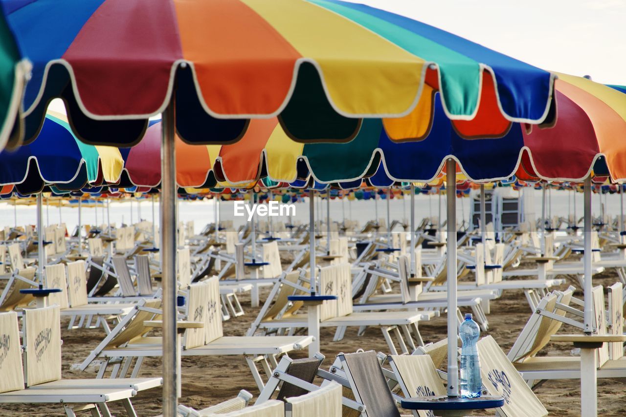 ROW OF CHAIRS ON BEACH