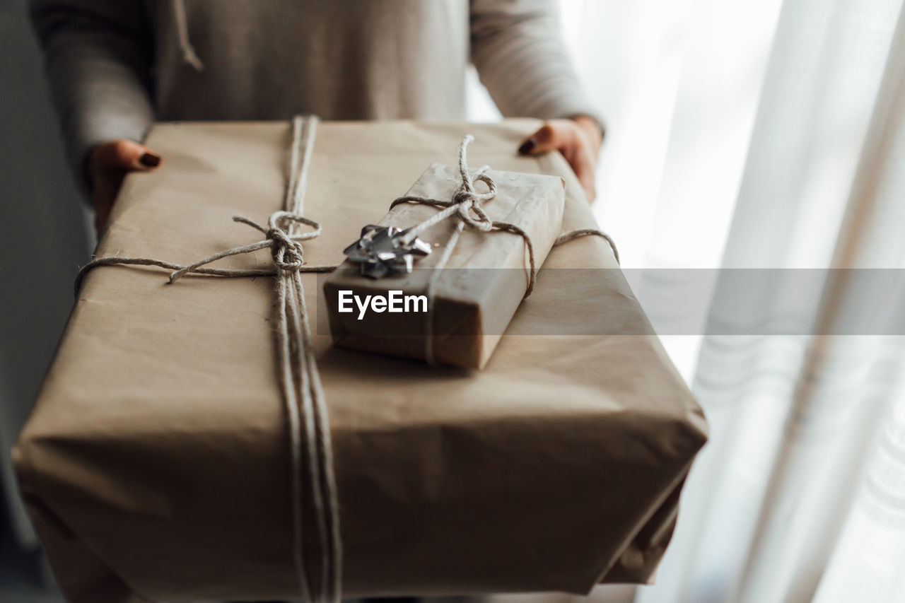 Midsection of woman holding christmas gift