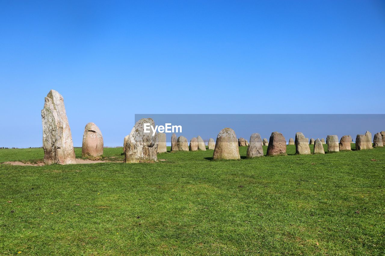 STONE WALL ON FIELD AGAINST CLEAR SKY