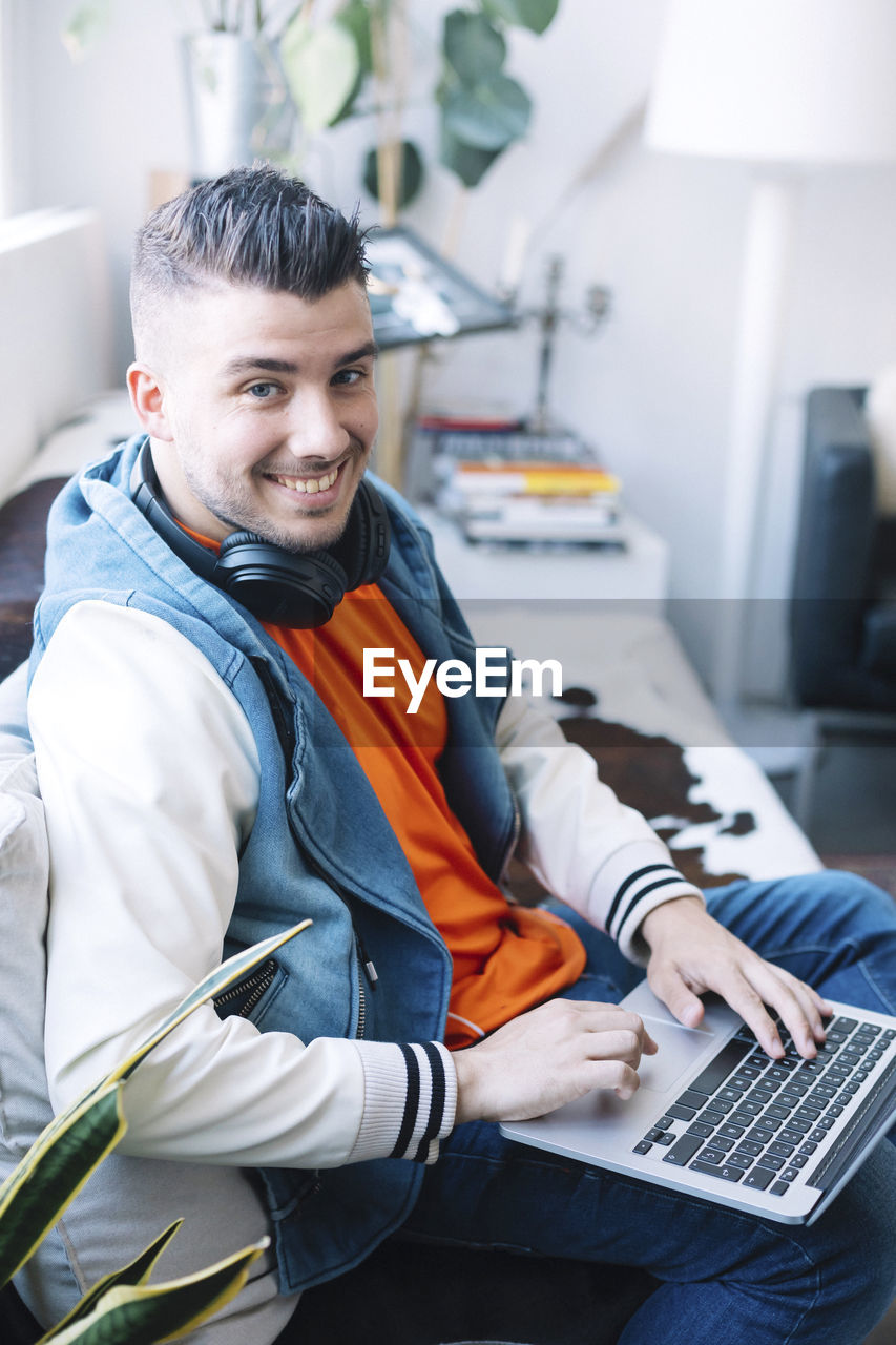 Portrait of young man using laptop