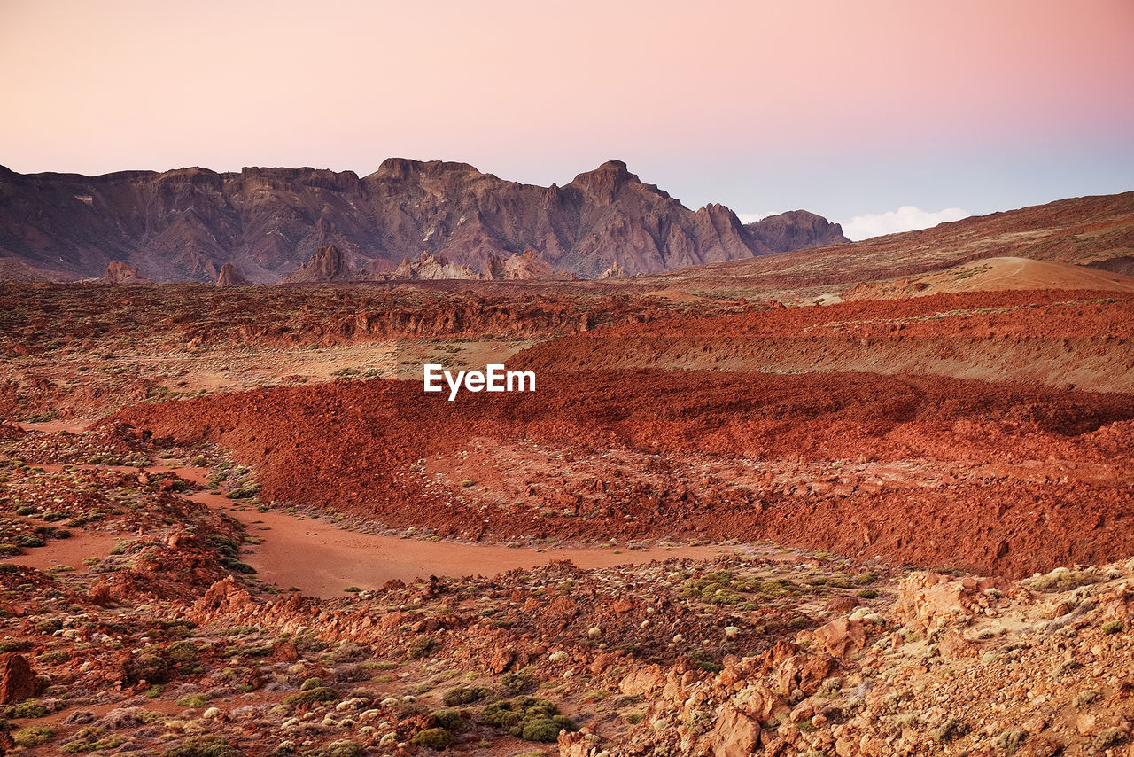 Scenic view of landscape at el teide national park against sky during sunset