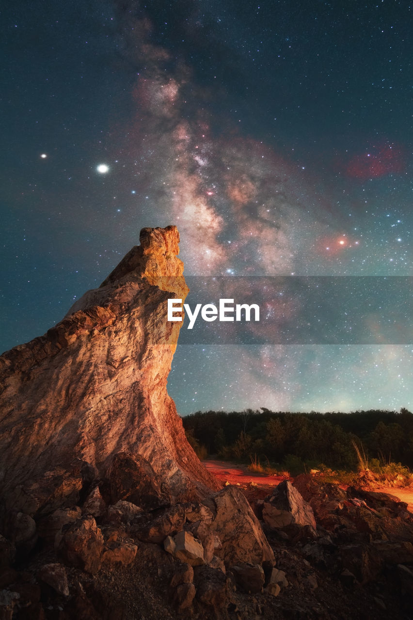 ROCK FORMATION ON LANDSCAPE AGAINST SKY