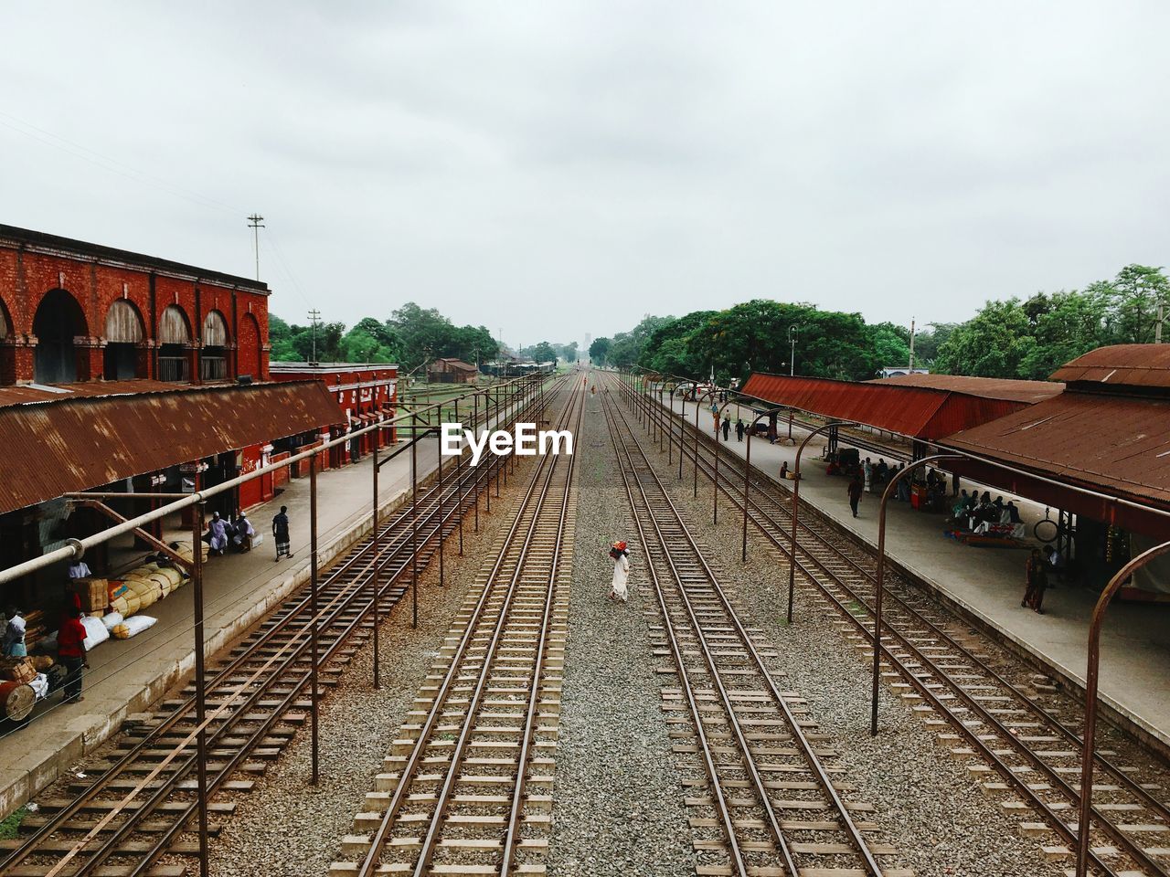 High angle view of man amidst railroad tracks at station