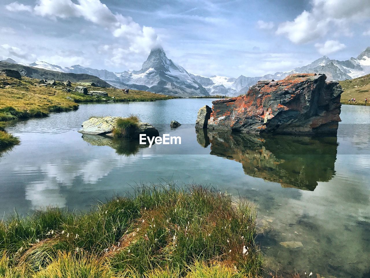 Scenic view of lake and mountains against sky