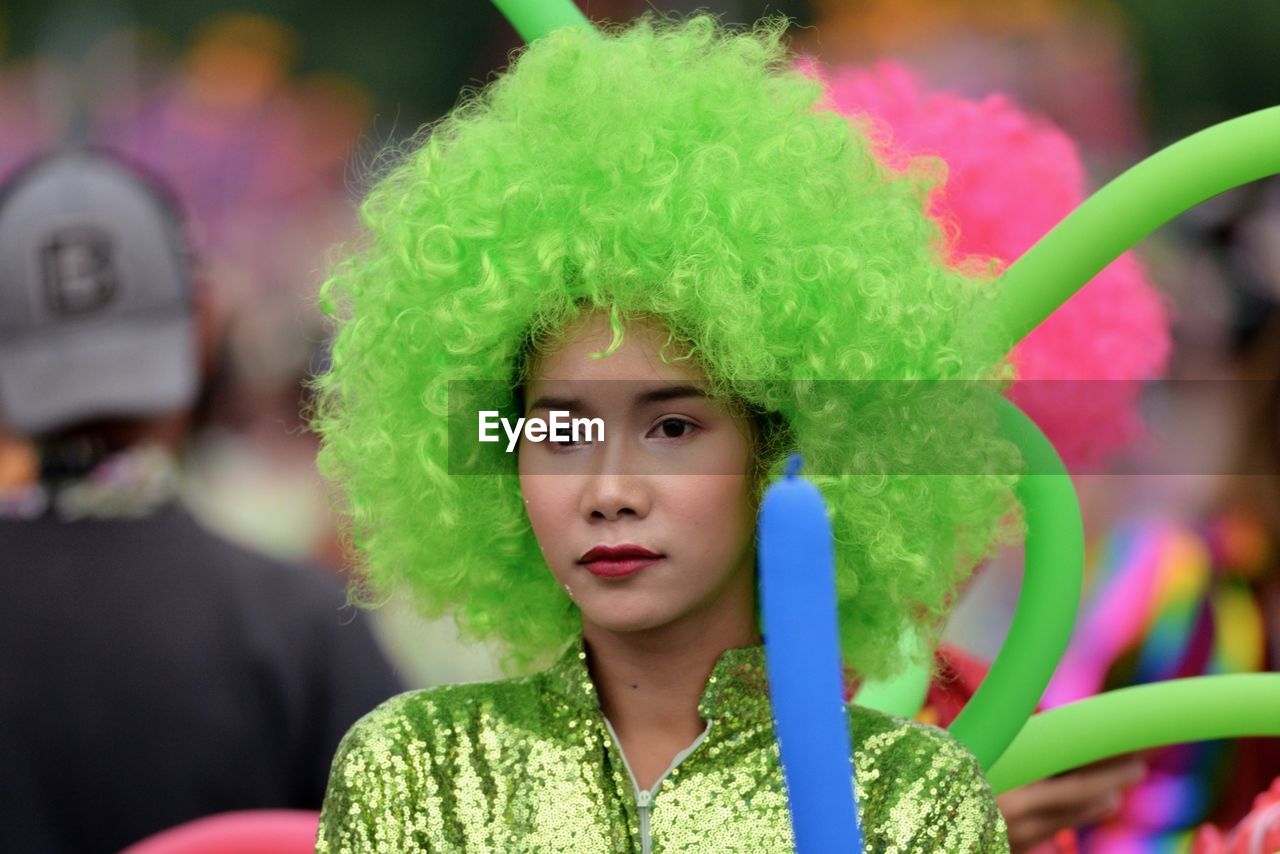 Young woman wearing green wig