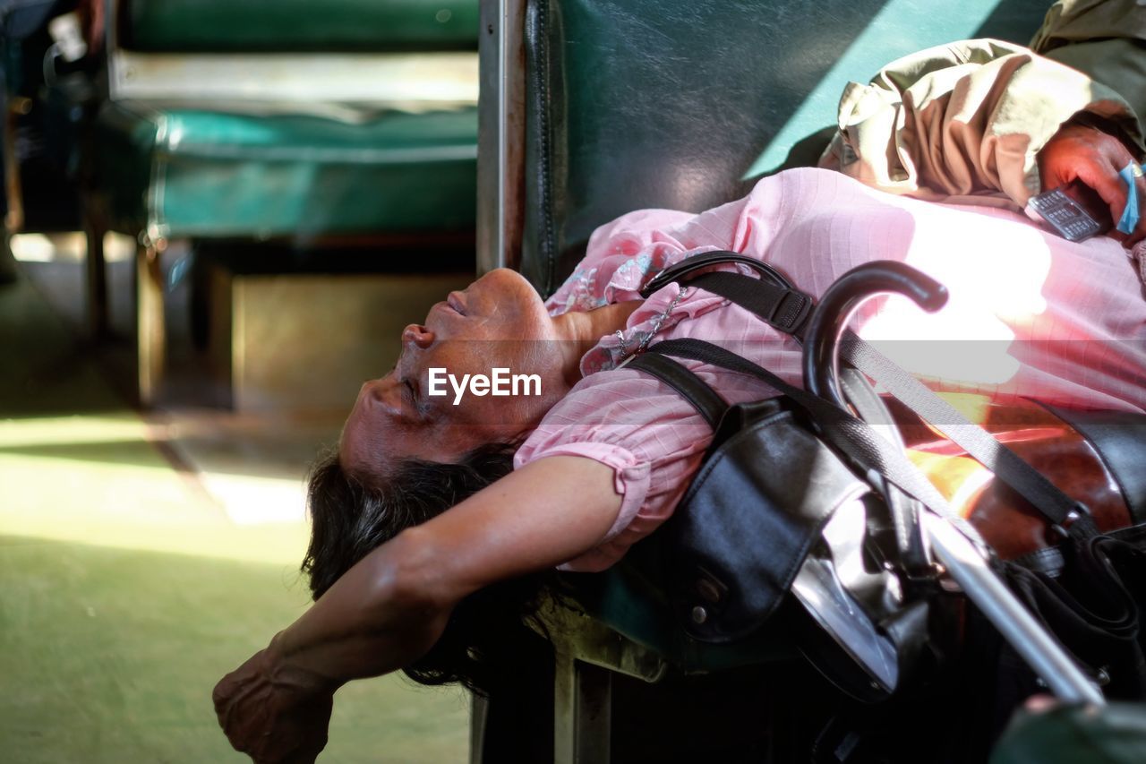 Midsection of woman lying on bench