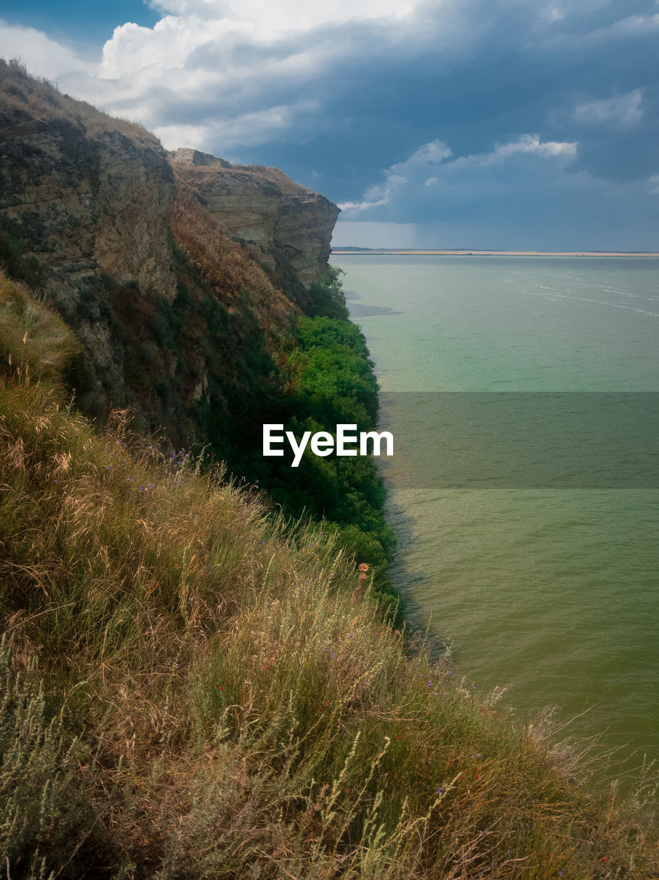 SCENIC VIEW OF SEA AND ROCKS AGAINST SKY