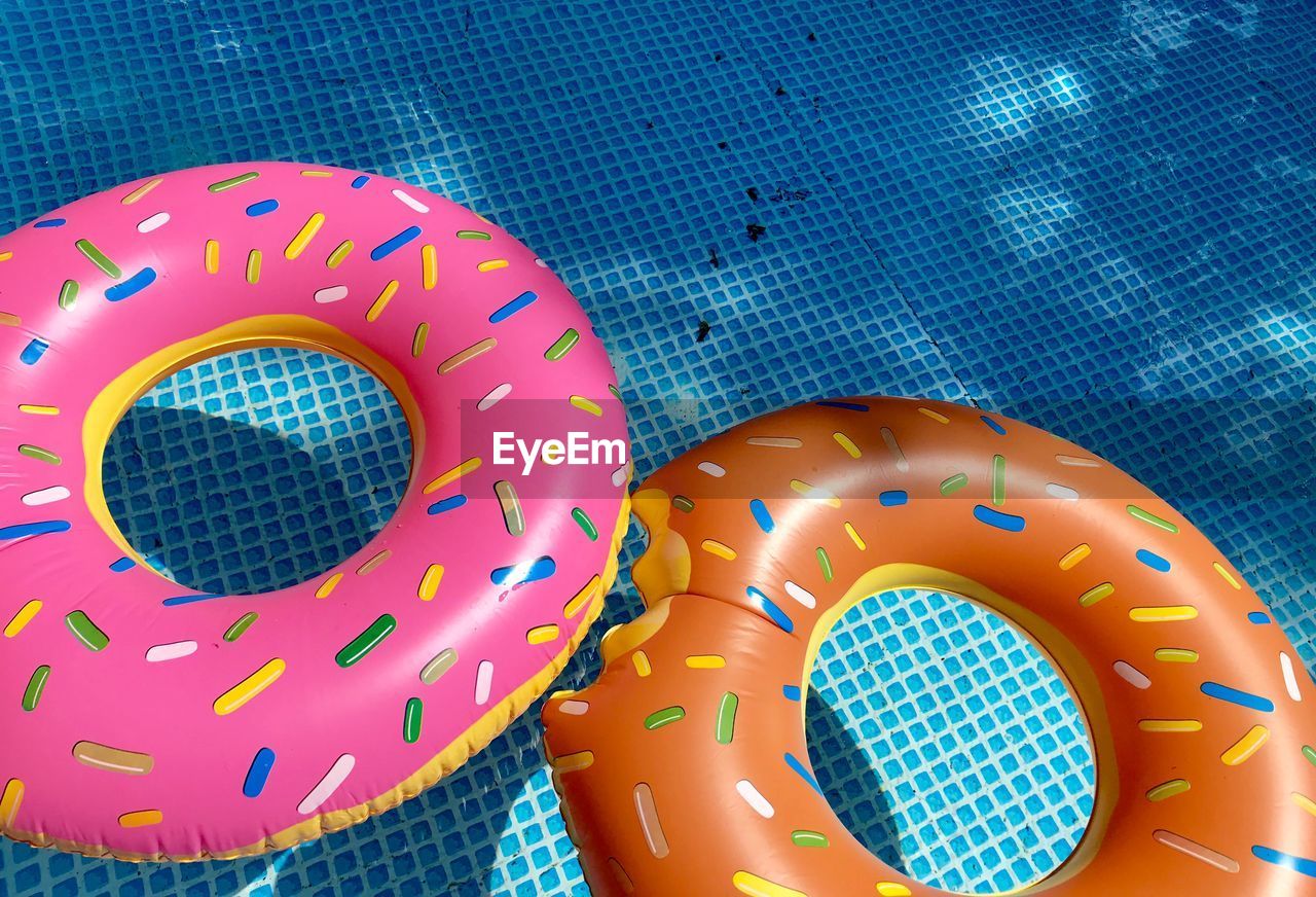 High angle view of inflatable rings floating in swimming pool