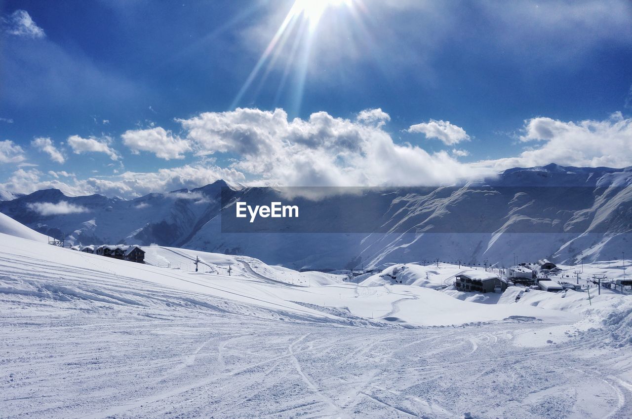 Scenic view of ski slope against sky
