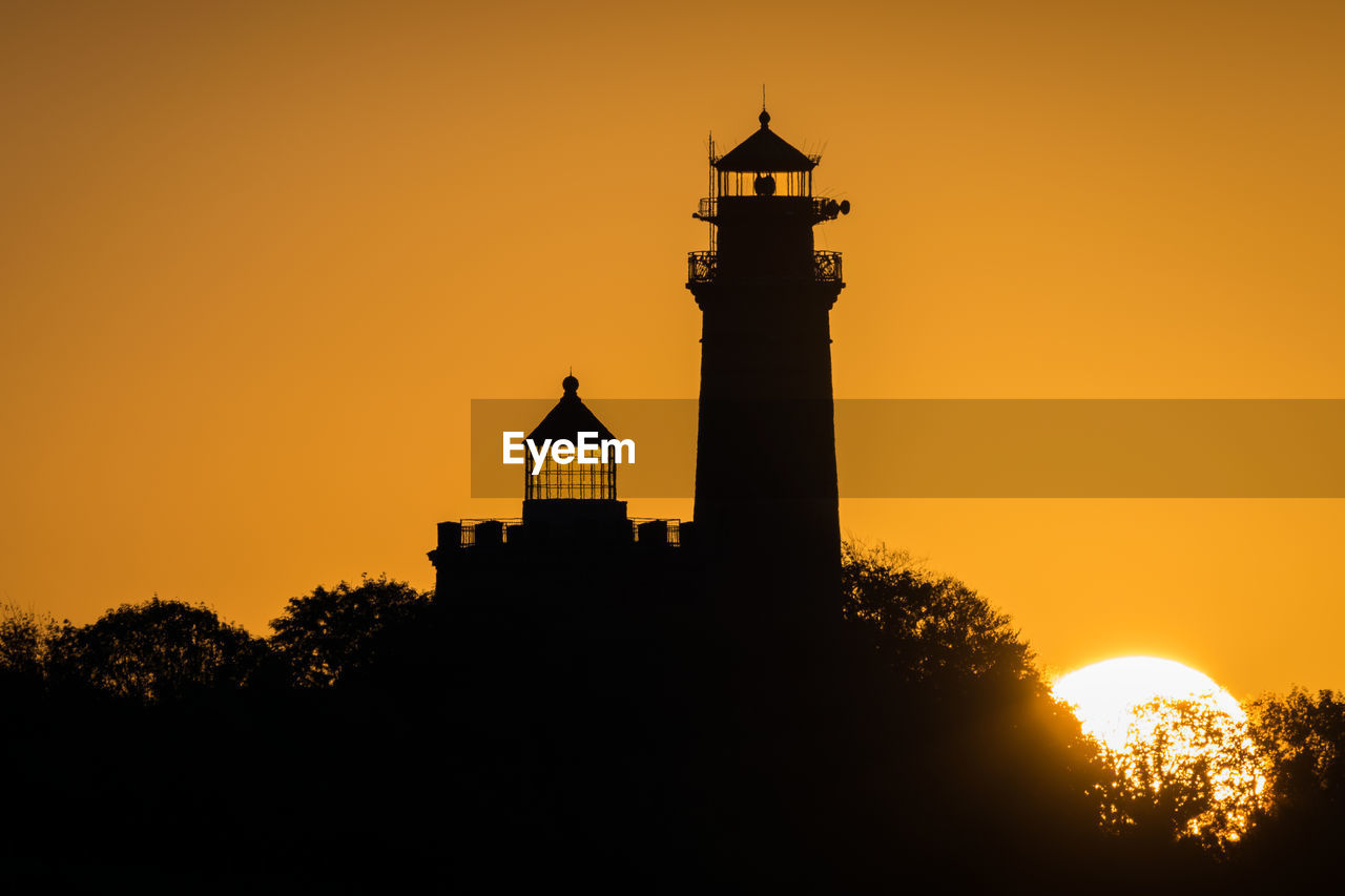 SILHOUETTE OF BUILDING AGAINST SKY AT SUNSET