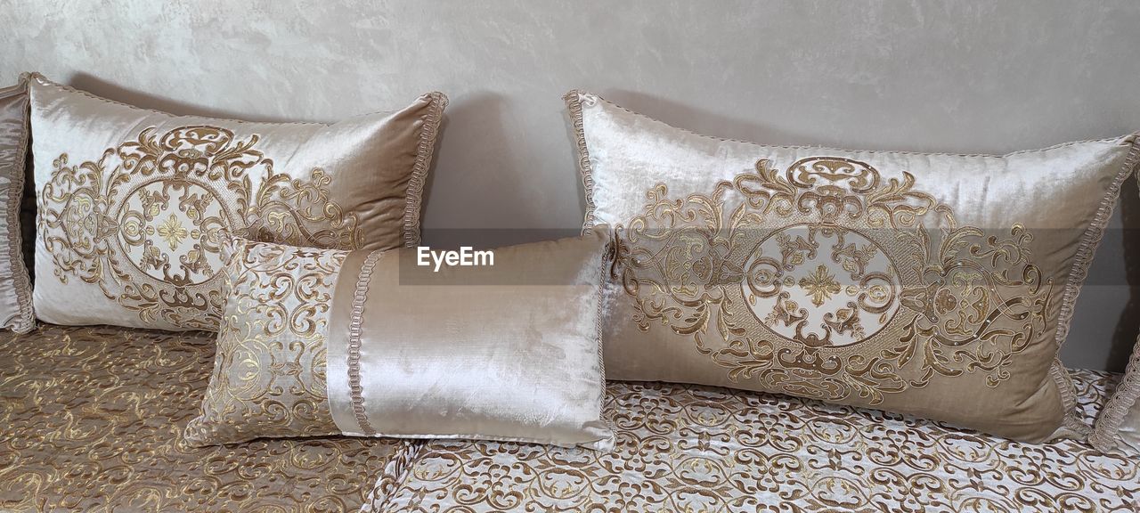 pillow, throw pillow, furniture, indoors, textile, cushion, no people, pattern, sofa, home interior, domestic room, luxury, white, bed sheet, wealth