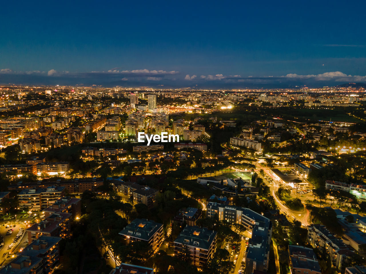 High angle view of illuminated city against sky