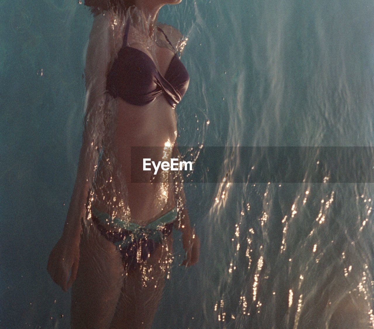 High angle view of woman wearing bikini swimming in sea