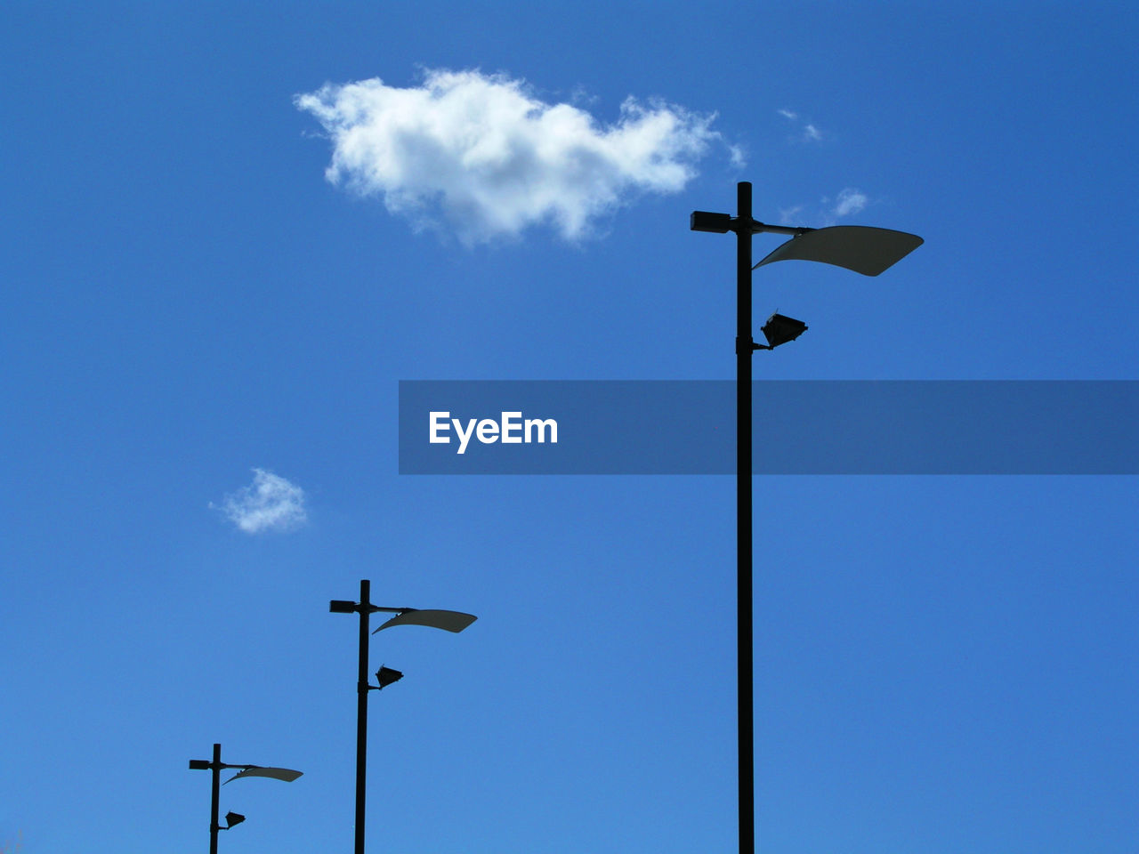 Low angle view of street lights against sky