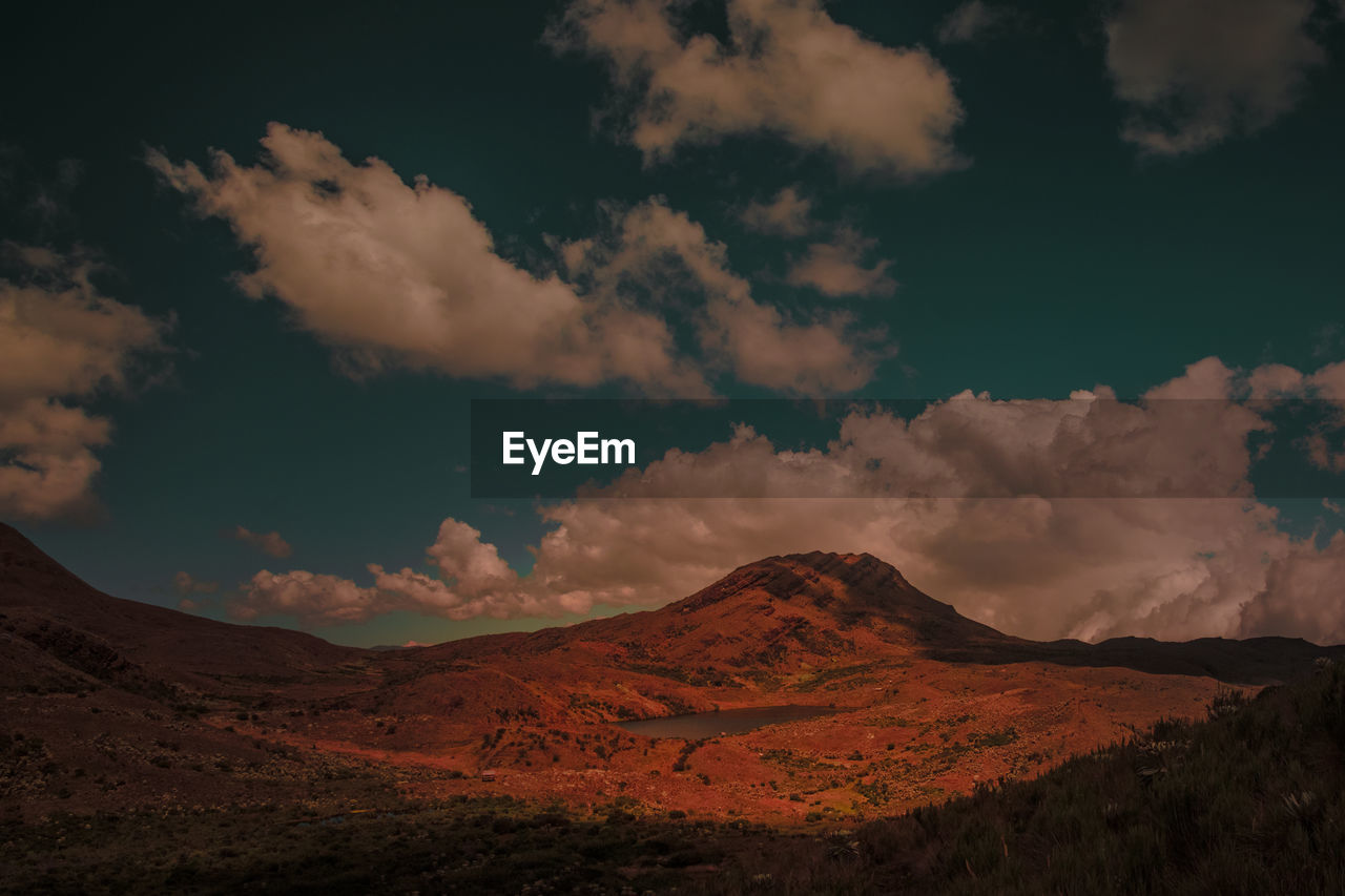 SCENIC VIEW OF CLOUDS OVER MOUNTAINS AGAINST SKY