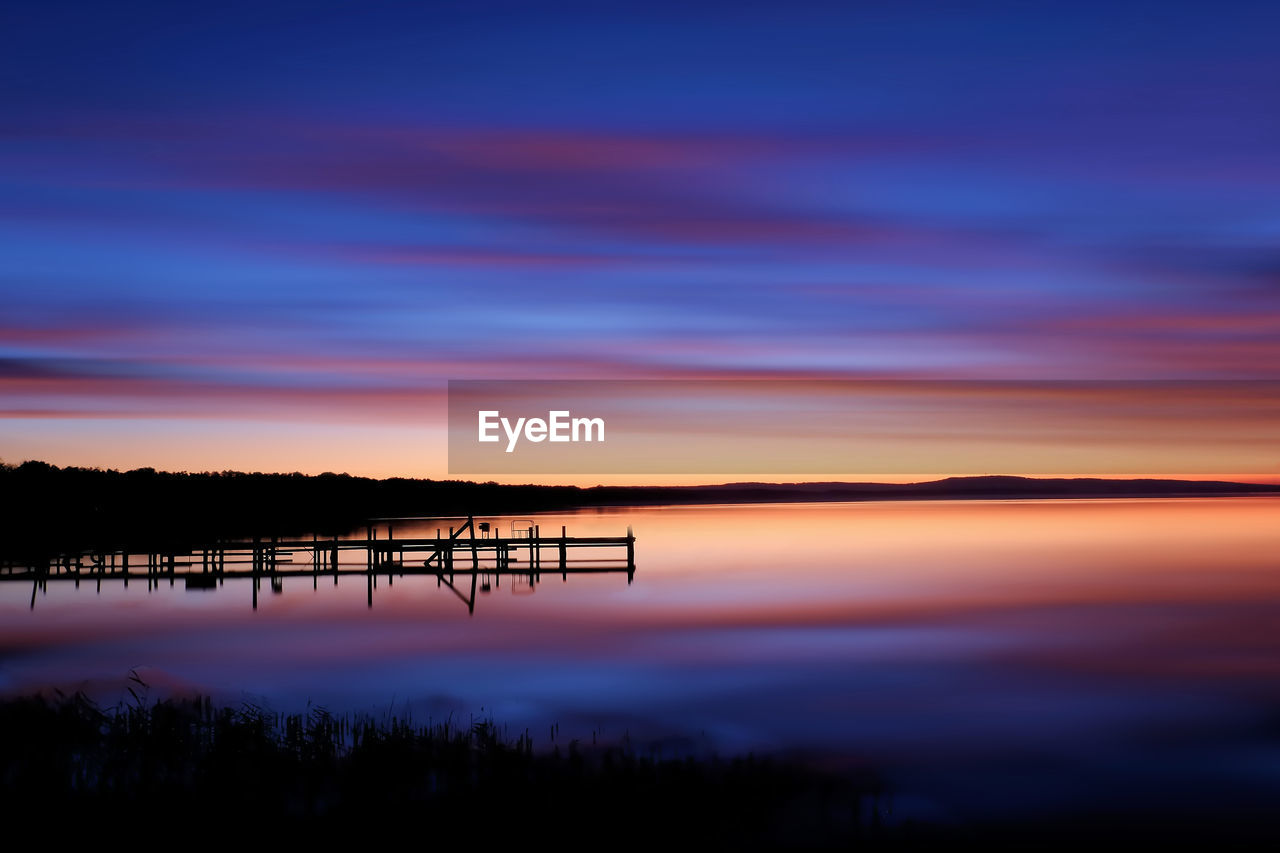 SCENIC VIEW OF SUNSET OVER LAKE