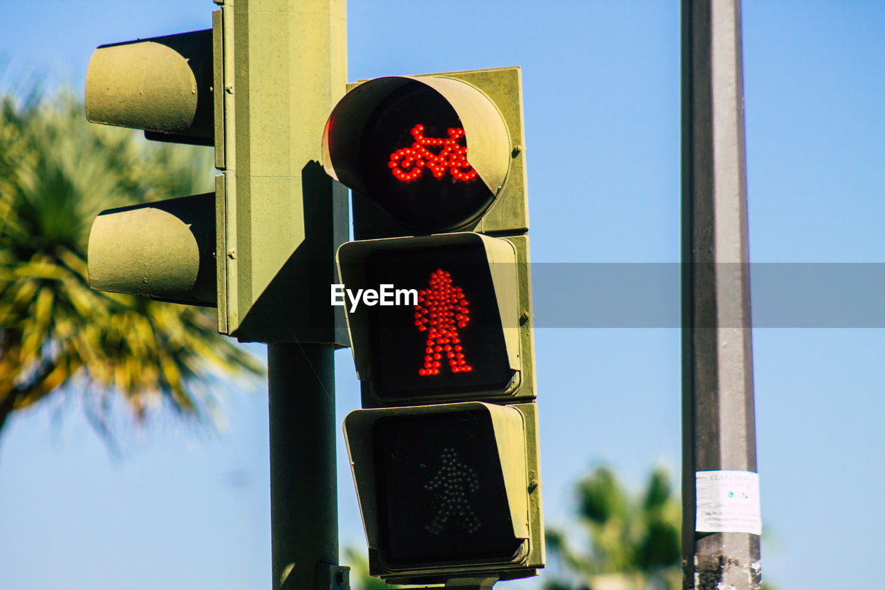 LOW ANGLE VIEW OF ROAD SIGN AGAINST BLUE SKY