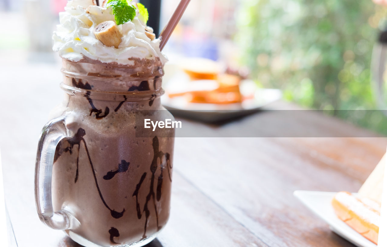 Chocolate frappe with whip cream on wood table