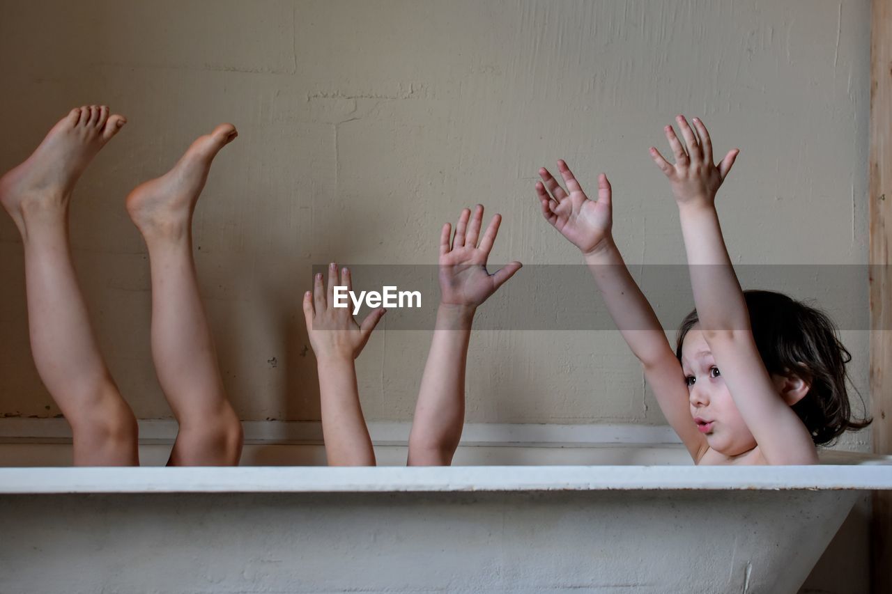 Playful brothers in bathtub at home