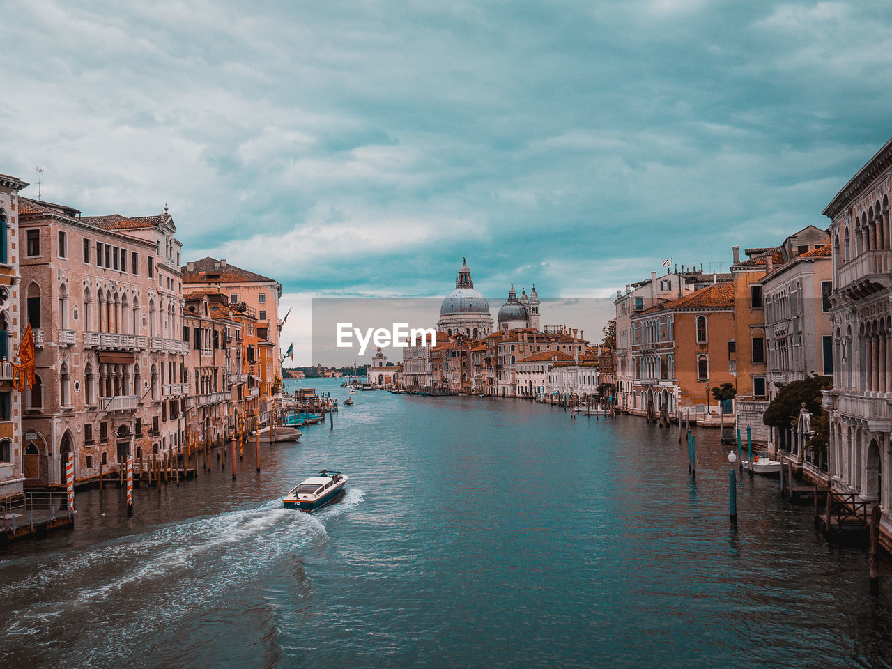 Canal passing through city buildings in venice, italy