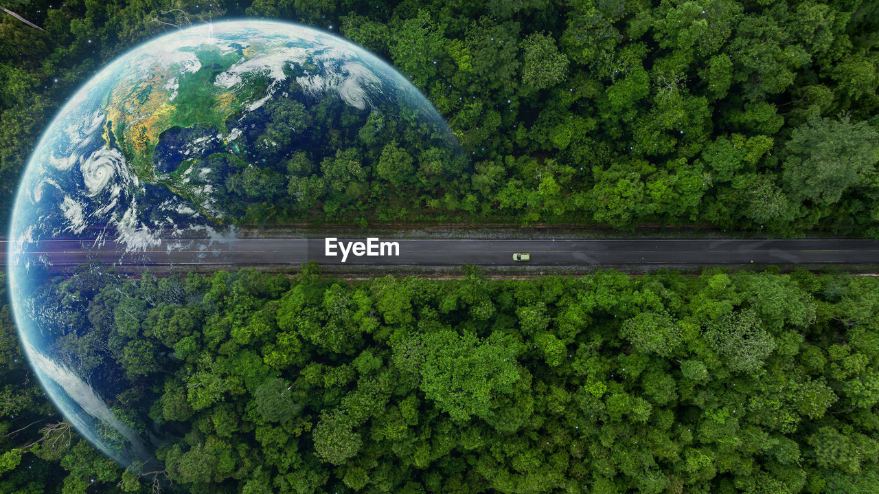 Aerial top view globe planet with electric vehicle car on asphalt road forest in tropical rainforest