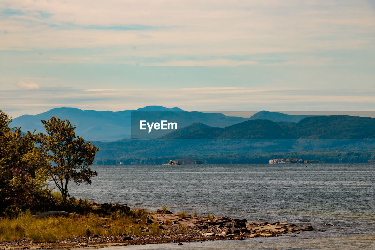 water, sky, nature, sea, morning, mountain, scenics - nature, horizon, beauty in nature, shore, body of water, coast, landscape, tranquility, dusk, cloud, tranquil scene, land, ocean, no people, reflection, environment, tree, plant, mountain range, beach, outdoors, bay, day, non-urban scene, idyllic, sunrise, travel, wilderness, travel destinations
