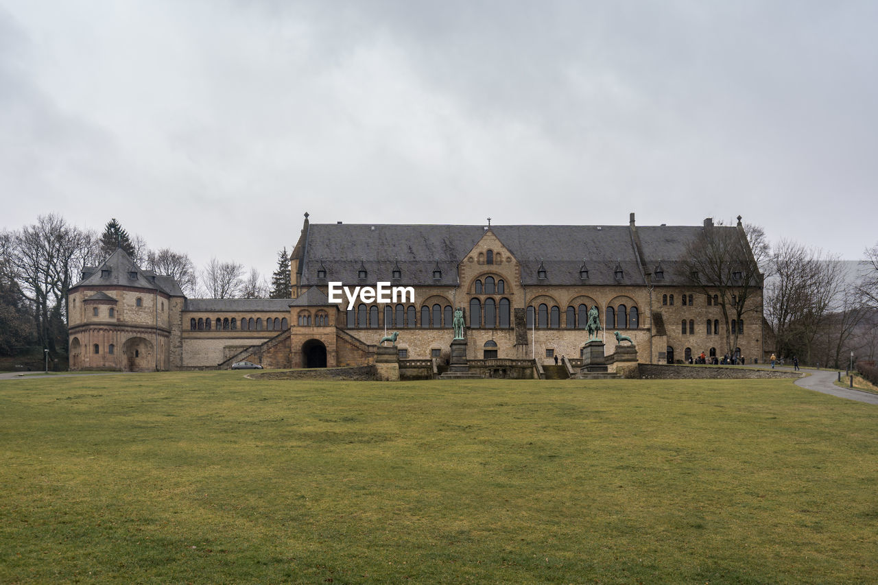 BUILT STRUCTURE ON FIELD AGAINST SKY