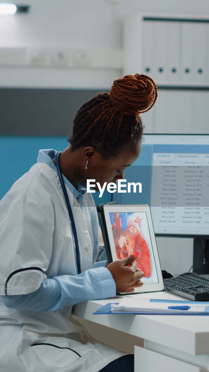 Female doctor using digital tablet at clinic