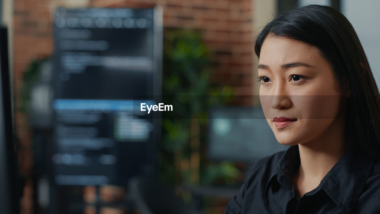 Serious businesswoman sitting at officer