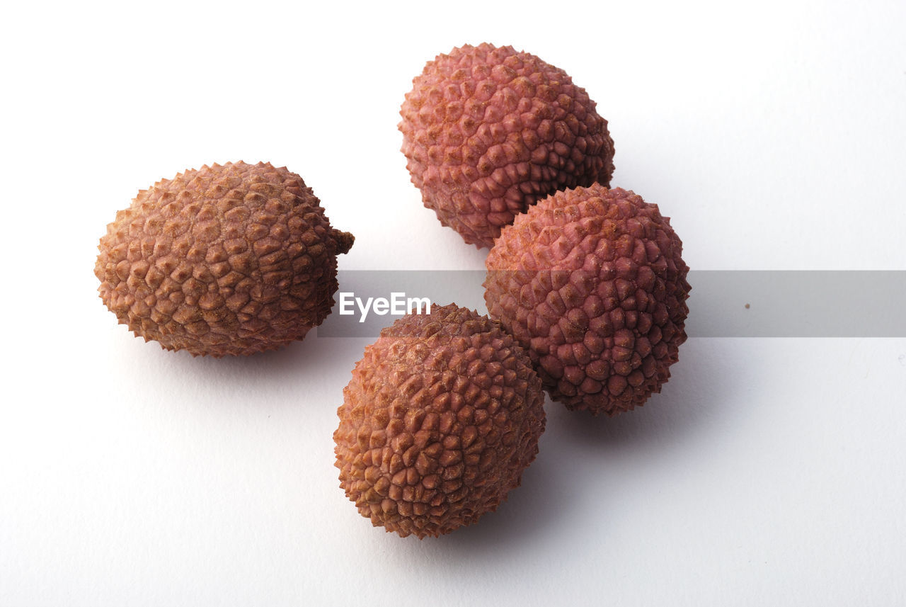 HIGH ANGLE VIEW OF FRUITS ON WHITE SURFACE