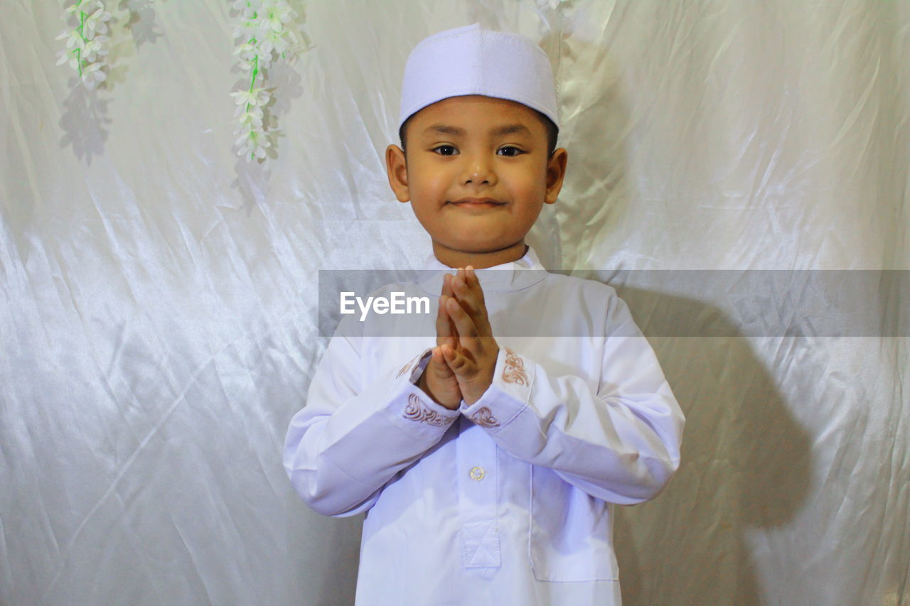 Portrait of cute boy standing at home