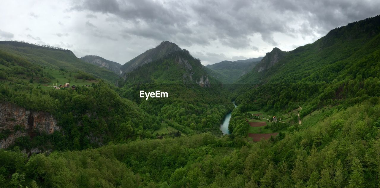 Scenic view of mountains against cloudy sky