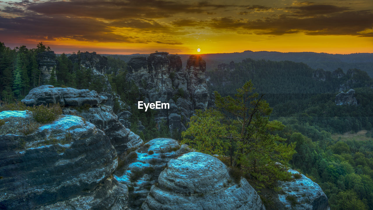 Scenic view of rocks against sky during sunset