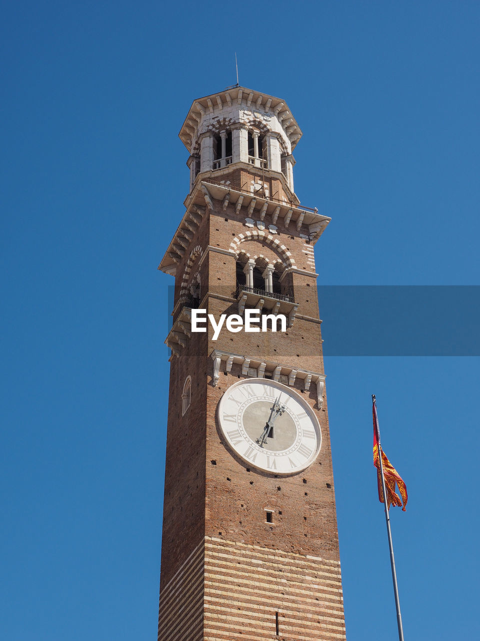 LOW ANGLE VIEW OF CLOCK TOWER AGAINST BLUE SKY
