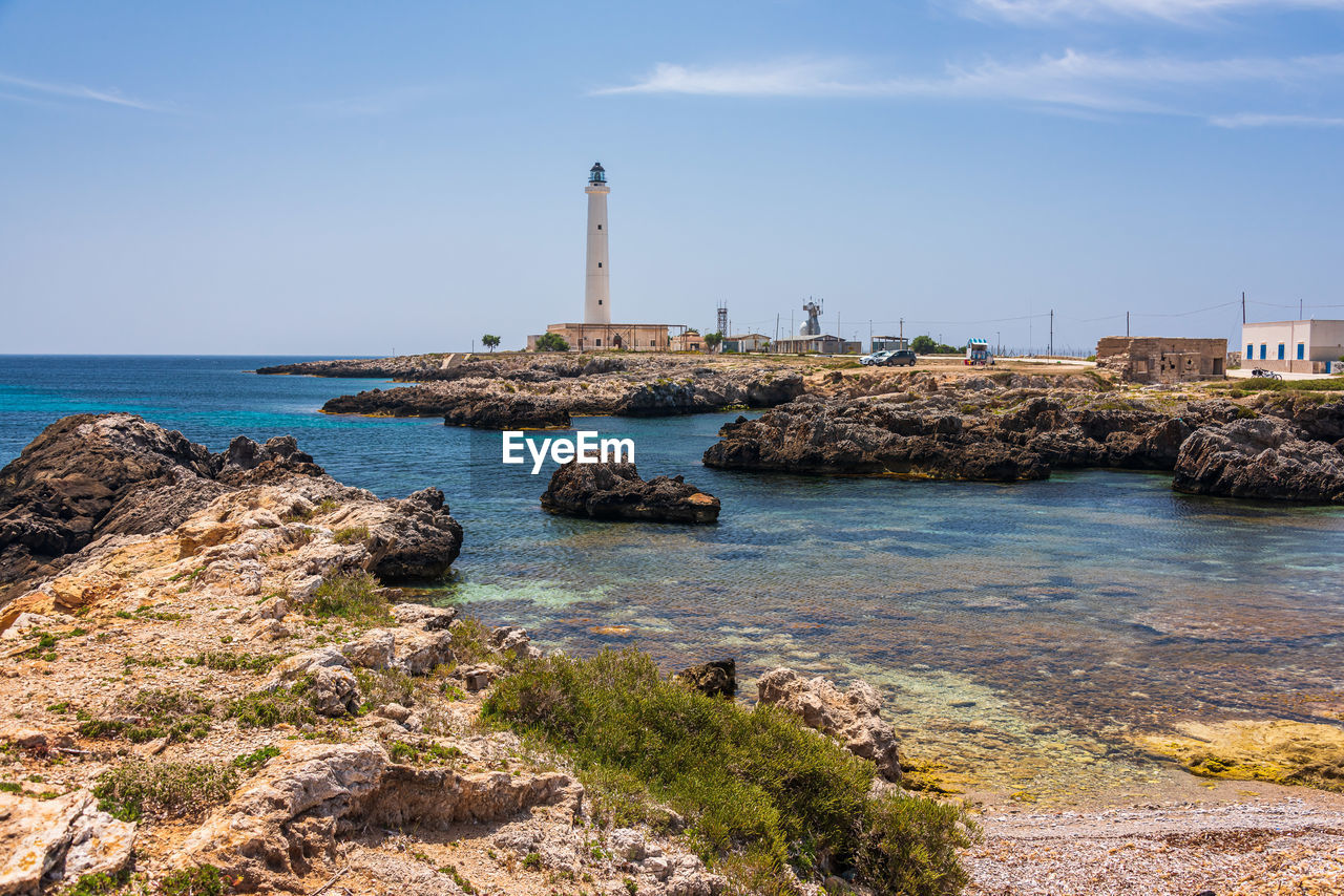 Scenic view of sea and lighthouse against sky