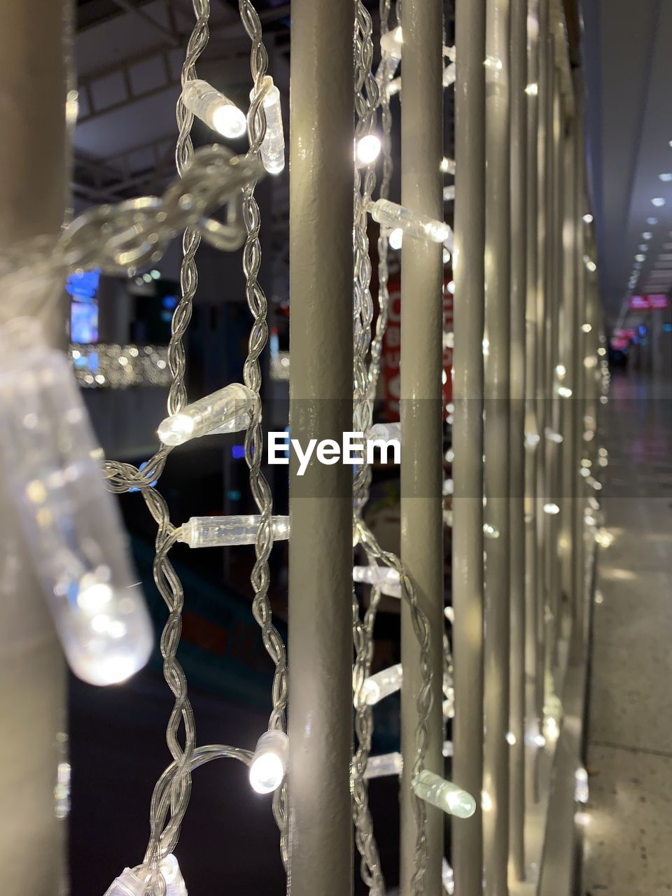 CLOSE-UP OF ILLUMINATED LIGHTING EQUIPMENT HANGING ON METAL