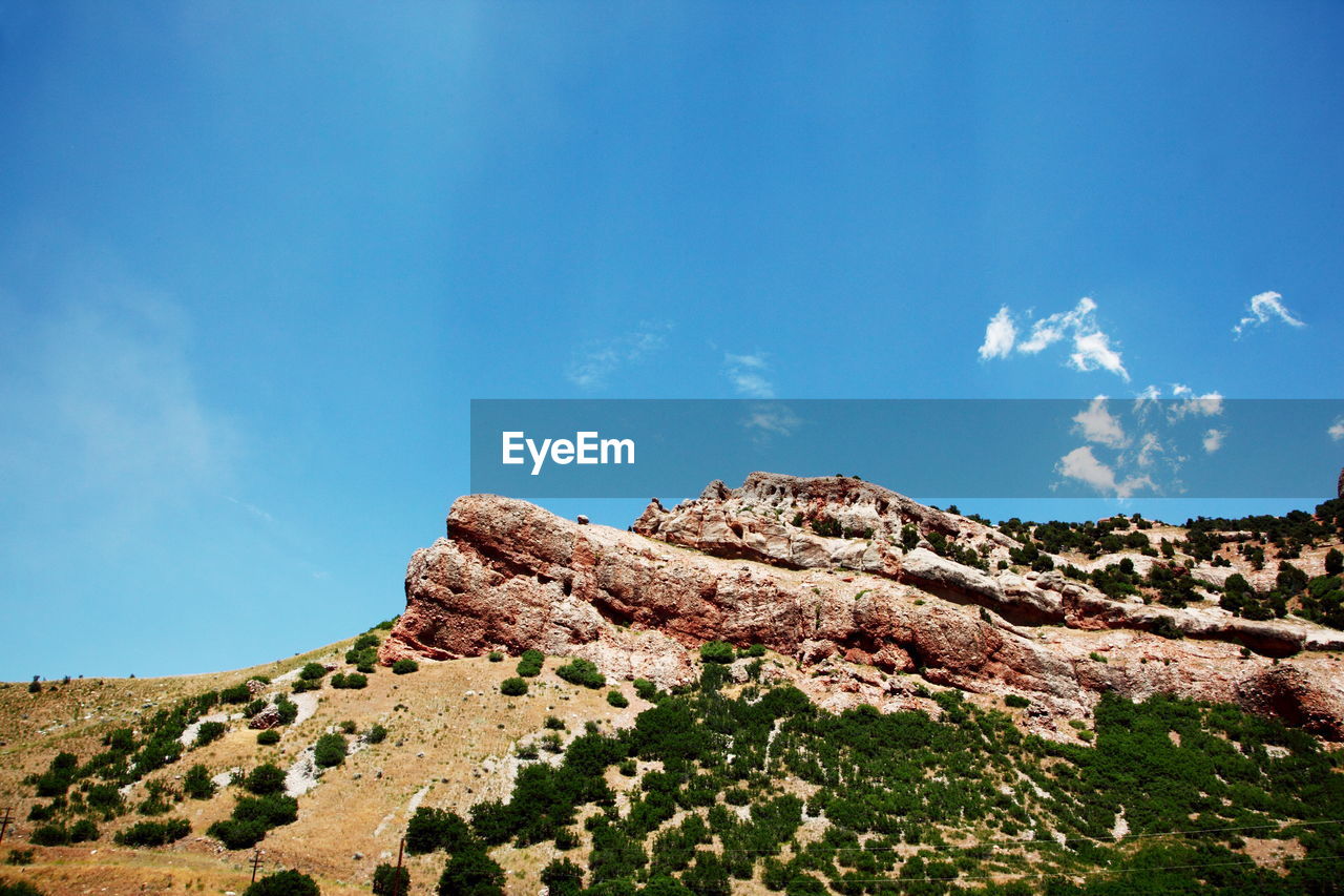 Scenic view of rock formation against blue sky