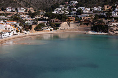 High angle view of townscape by sea